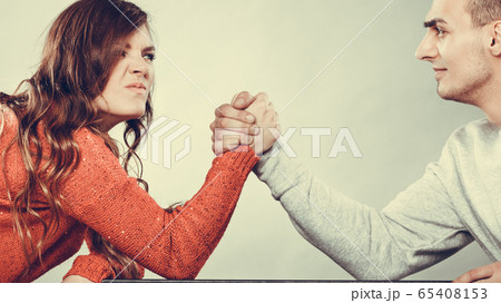 Arm wrestling challenge between young couple Arm wrestling challenge between young couple 65408153