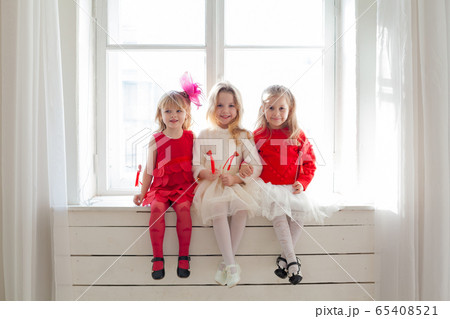 three girl girlfriends sitting by a window in a room three girl girlfriends sitting by a window in a room 65408521