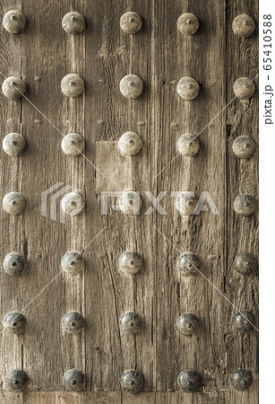 Old wooden door in a medieval building 65410588