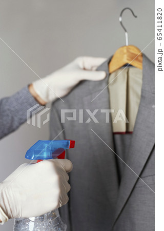 man disinfecting a sport jacket man disinfecting a sport jacket 65411820