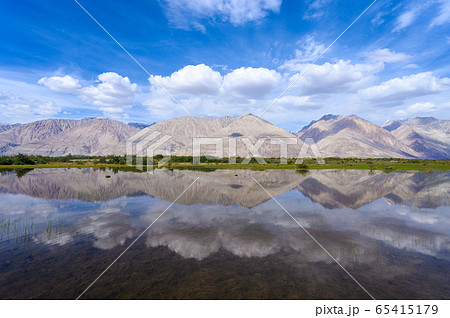 Beautiful view of lake and blue sky reflected in Nubra Valley in summer Beautiful view of lake and blue sky reflected in Nubra Valley in summer 65415179