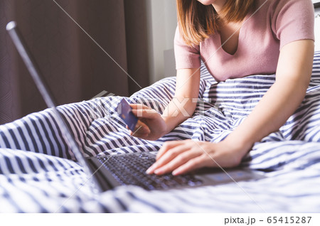 Online shopping concept, Young asian woman using laptop shopping by credit card 65415287