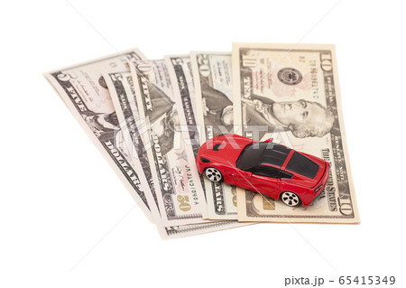 Red toy car on ten dollar banknotes, isolated on 65415349