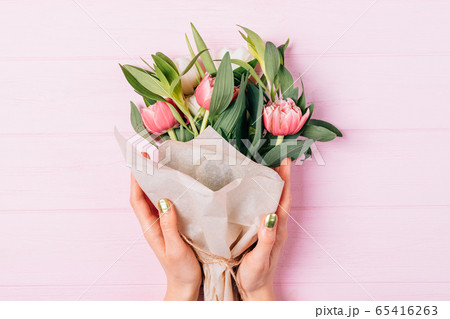 Top view of female hands holding lush bouquet of Top view of female hands holding lush bouquet of 65416263