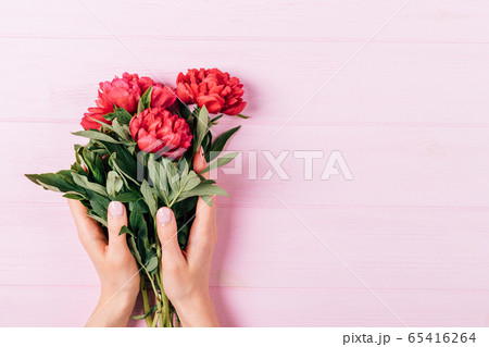 Female hands with manicure hold bouquet of fresh 65416264