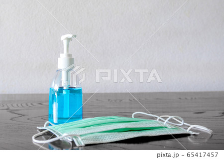 Picture of medical surgical mask and alcohol hand sanitizer, wash dirt to prevent germs 65417457