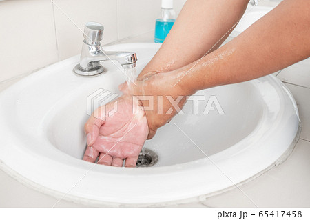 Men's hands wash their hands with soap clean hands in the tub with soap, personal hygiene 65417458