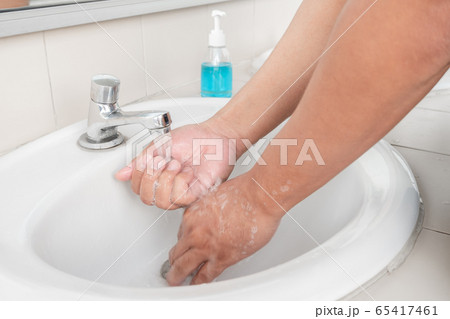 Men's hands wash their hands with soap clean hands in the tub with soap, personal hygiene 65417461