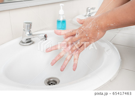 Men's hands wash their hands with soap clean hands in the tub with soap, personal hygiene 65417463