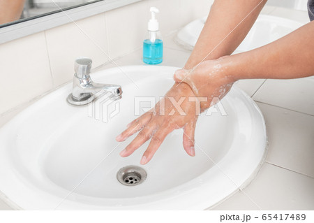 Men's hands wash their hands with soap clean hands in the tub with soap, personal hygiene 65417489