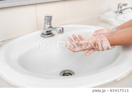 Woman's hands wash their hands with soap cleanse the hands in the tub with soap, personal hygiene Woman's hands wash their hands with soap cleanse the hands in the tub with soap, personal hygiene 65417513