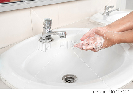 Woman's hands wash their hands with soap cleanse the hands in the tub with soap, personal hygiene Woman's hands wash their hands with soap cleanse the hands in the tub with soap, personal hygiene 65417514
