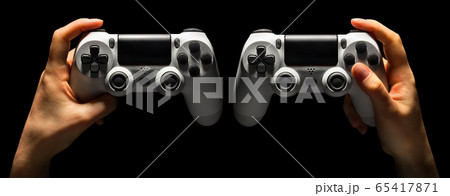 Set of hands holding video game gamepad in neon lights isolated on a black Set of hands holding video game gamepad in neon lights isolated on a black 65417871