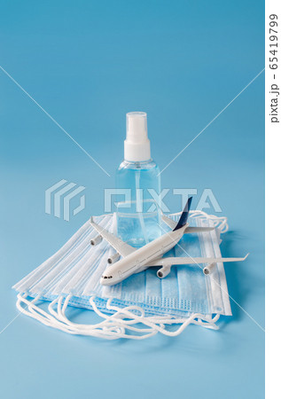 Travel and Tourism Planning after Quarantine. Airplane model, face mask and hand sanitizer Travel and Tourism Planning after Quarantine. Airplane model, face mask and hand sanitizer 65419799