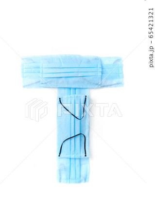 Letter T made from protective medical masks on a white background. 65421321