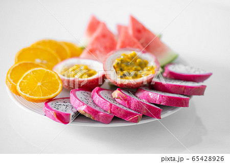 White plate of sliced fruit. Fresh fruits and White plate of sliced fruit. Fresh fruits and 65428926