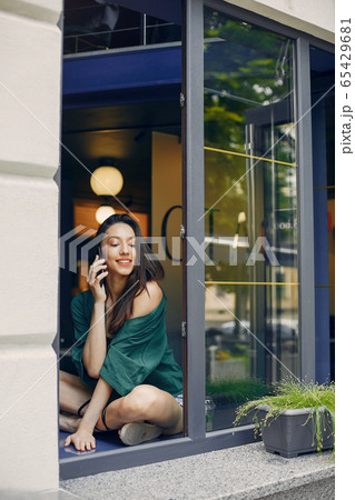 Fashion girl standing in a summer cafe 65429681