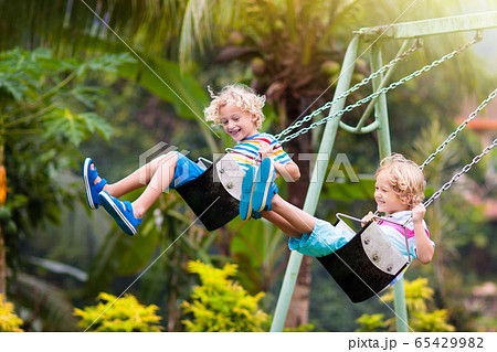 Child on playground. swing Kids play outdoor. Child on playground. swing Kids play outdoor. 65429982