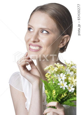 Close-up portrait of beautiful young woman with flowers Close-up portrait of beautiful young woman with flowers 65430277