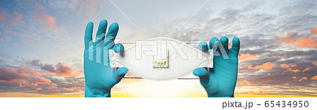 Doctor showing protective mask on sky clouds 65434950