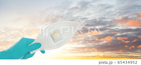 Doctor giving protective mask against sky clouds 65434952