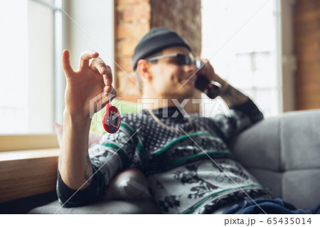 Portrait of millenial boy using retro toys, meeting things from the past and having fun, exploring tamagotchi, virtual pet game Portrait of millenial boy using retro toys, meeting things from the past and having fun, exploring tamagotchi, virtual pet game 65435014