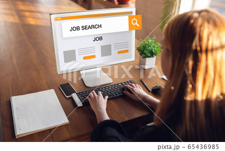 Woman typing while looking for a job during worldwide crisis of coronavirus pandemic. Find a job online. Business, internet and networking concept. 65436985