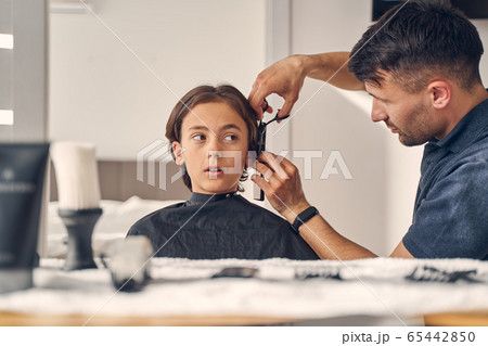 Small boy getting new haircut at home 65442850