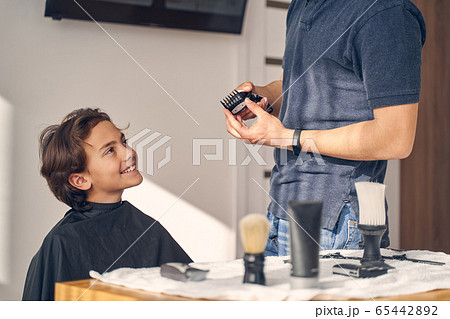 Little boy looking at man and smiling 65442892