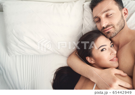 Young man hugging his wife during sleep Young man hugging his wife during sleep 65442949
