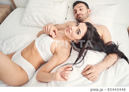 Dreamy Caucasian man holding his wifes hand Dreamy Caucasian man holding his wifes hand 65443446