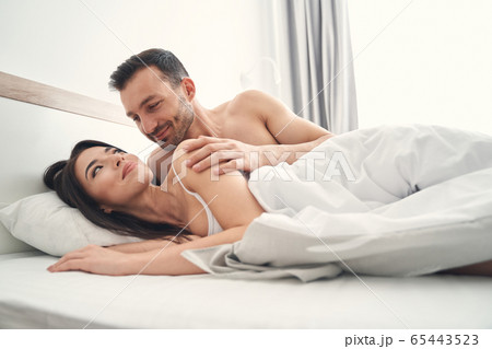 Happy lady gazing tenderly at a man Happy lady gazing tenderly at a man 65443523