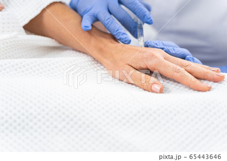 Mature woman getting a dermal filler injection Mature woman getting a dermal filler injection 65443646
