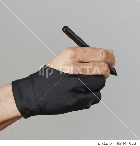 man wearing a two finger glove using a graphic pen 65444023