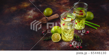 Lime Lemonade with thyme, cranberry and ice. 65446130