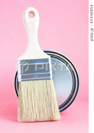 Paint metal can and new brush on pink background. Focus on brush. House renovation. Hobby. Color therapy Paint metal can and new brush on pink background. Focus on brush. House renovation. Hobby. Color therapy 65446854