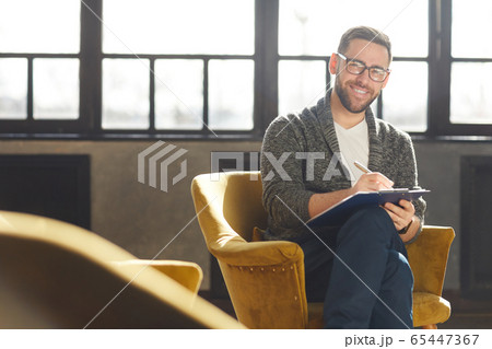 Successful businessman at office Successful businessman at office 65447367