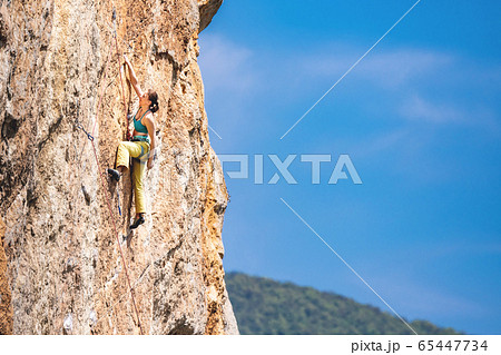 Woman climbs a rock. Woman climbs a rock. 65447734