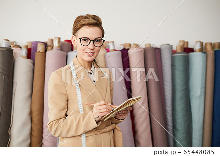 Designer planning her work Designer planning her work 65448085