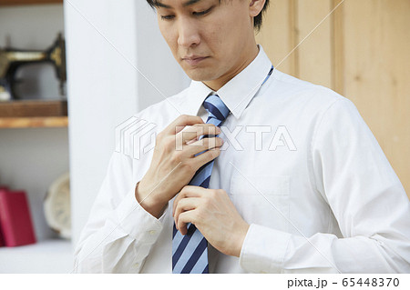 ネクタイを結ぶ若い男性の写真素材