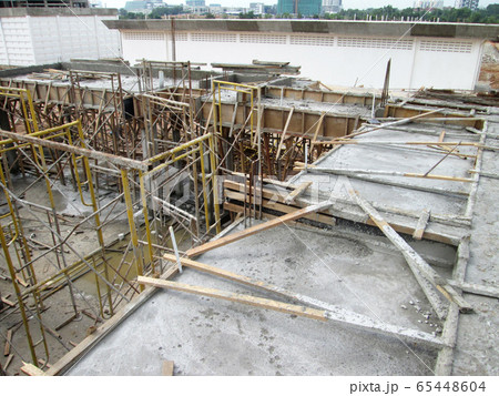 KUALA LUMPUR, MALAYSIA -JULY 14, 2017: Construction workers fabricating steel reinforcement bar at the construction site. The reinforcement bar was tie together using tiny wires.   65448604