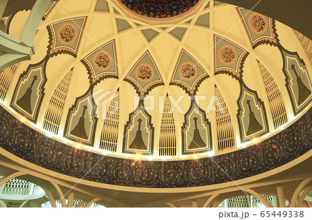 SARAWAK, MALAYSIA -OCTOBER 14, 2014: The interior of Sarawak State Mosque. The mosque has one big main prayer hall covered with one big and beautiful dome and supported with other small domes. SARAWAK, MALAYSIA -OCTOBER 14, 2014: The interior of Sarawak State Mosque. The mosque has one big main prayer hall covered with one big and beautiful dome and supported with other small domes. 65449338