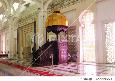 SARAWAK, MALAYSIA -OCTOBER 14, 2014: The interior of Sarawak State Mosque. The mosque has one big main prayer hall covered with one big and beautiful dome and supported with other small domes. SARAWAK, MALAYSIA -OCTOBER 14, 2014: The interior of Sarawak State Mosque. The mosque has one big main prayer hall covered with one big and beautiful dome and supported with other small domes. 65449354
