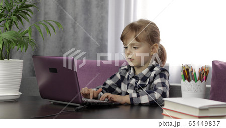 Girl studying online homework using digital laptop computer. Distance education 65449837