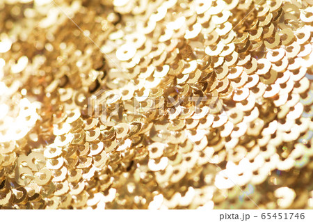 Sparkling golden sequined fabric. 65451746