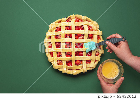 Making a strawberries tart. Greasing with egg yolk Making a strawberries tart. Greasing with egg yolk 65452012