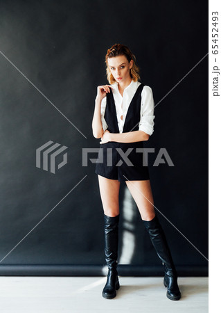 Beautiful fashionable blonde woman in white shirt and shorts 65452493