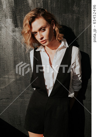 Beautiful fashionable blonde woman in white shirt and shorts Beautiful fashionable blonde woman in white shirt and shorts 65452496