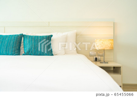 Pillow and blanket on bed with light lamp decoration interior 65455066