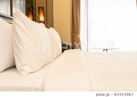Pillow and blanket on bed with light lamp decoration interior 65455067